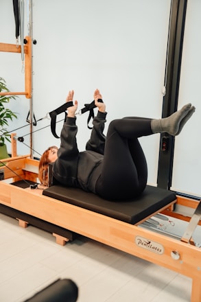 a woman is doing exercises on a rowing machine