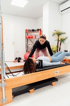 a couple of women are doing exercises in a gym
