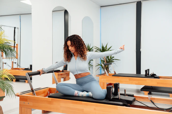 A woman doing a reformer exercise