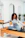 a woman sitting on a piyor in a gym