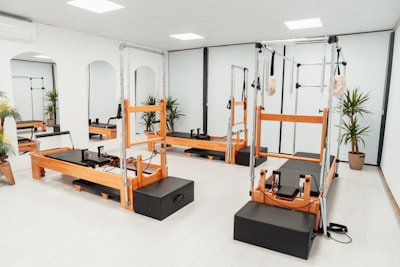 a gym with a row of machines and mirrors