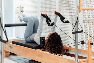a woman is doing exercises on a rowing machine