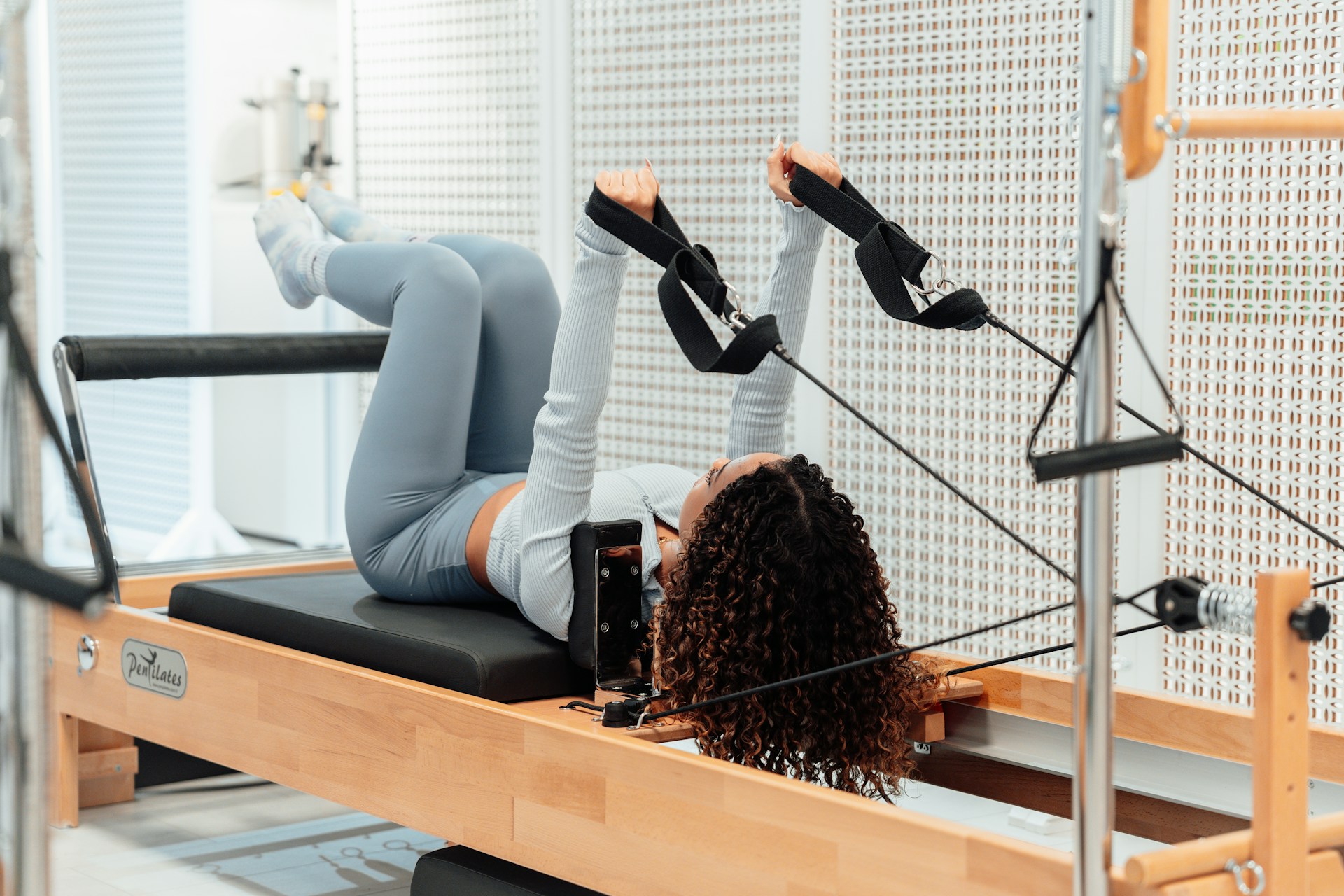 a woman is doing exercises on a rowing machine