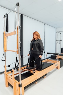 a woman standing on a machine in a room