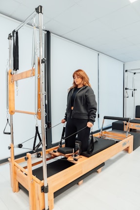 a woman standing on a machine in a room