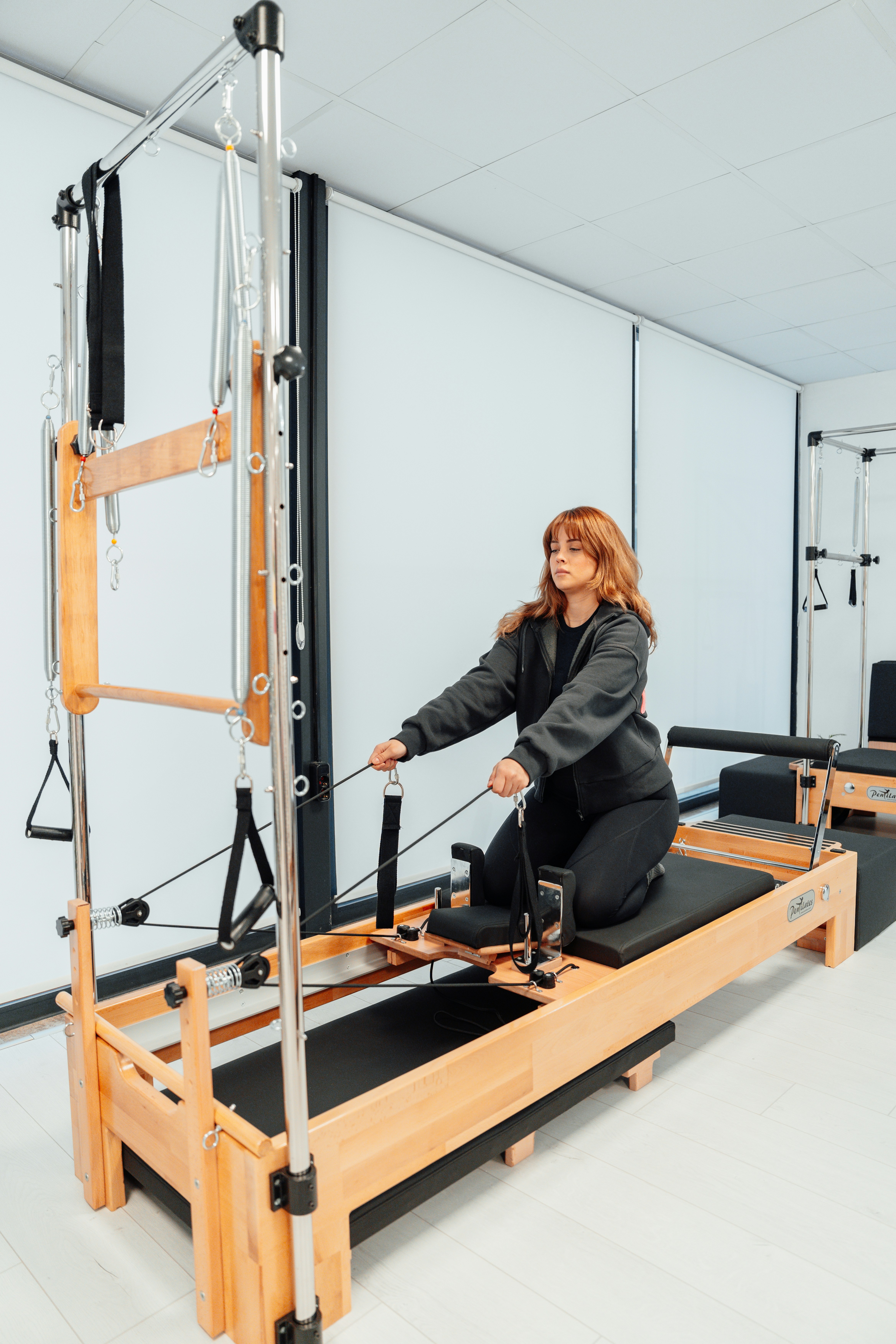 a woman is sitting on a machine in a room