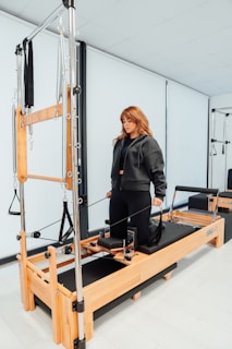 a woman standing on a machine in a room