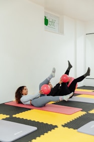 a couple of women laying on top of yoga mats