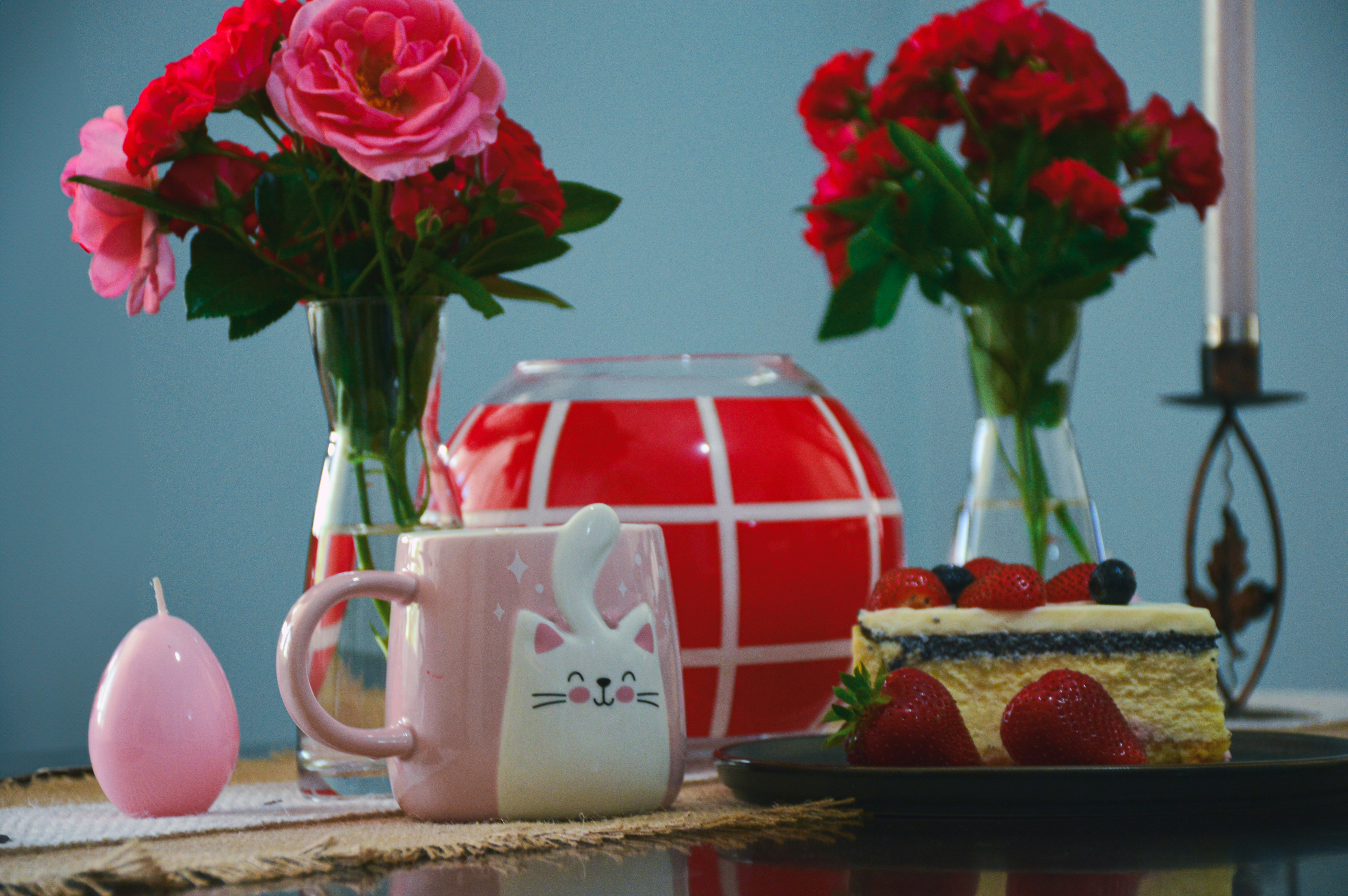 a table topped with a cake and flowers