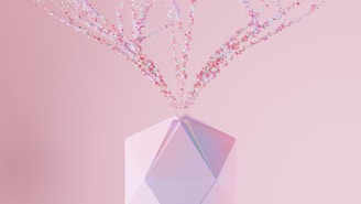 a crystal vase with pink flowers in it