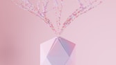 a crystal vase with pink flowers in it