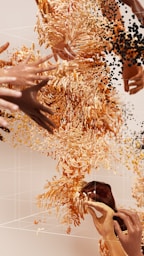 a group of hands reaching for a cell phone