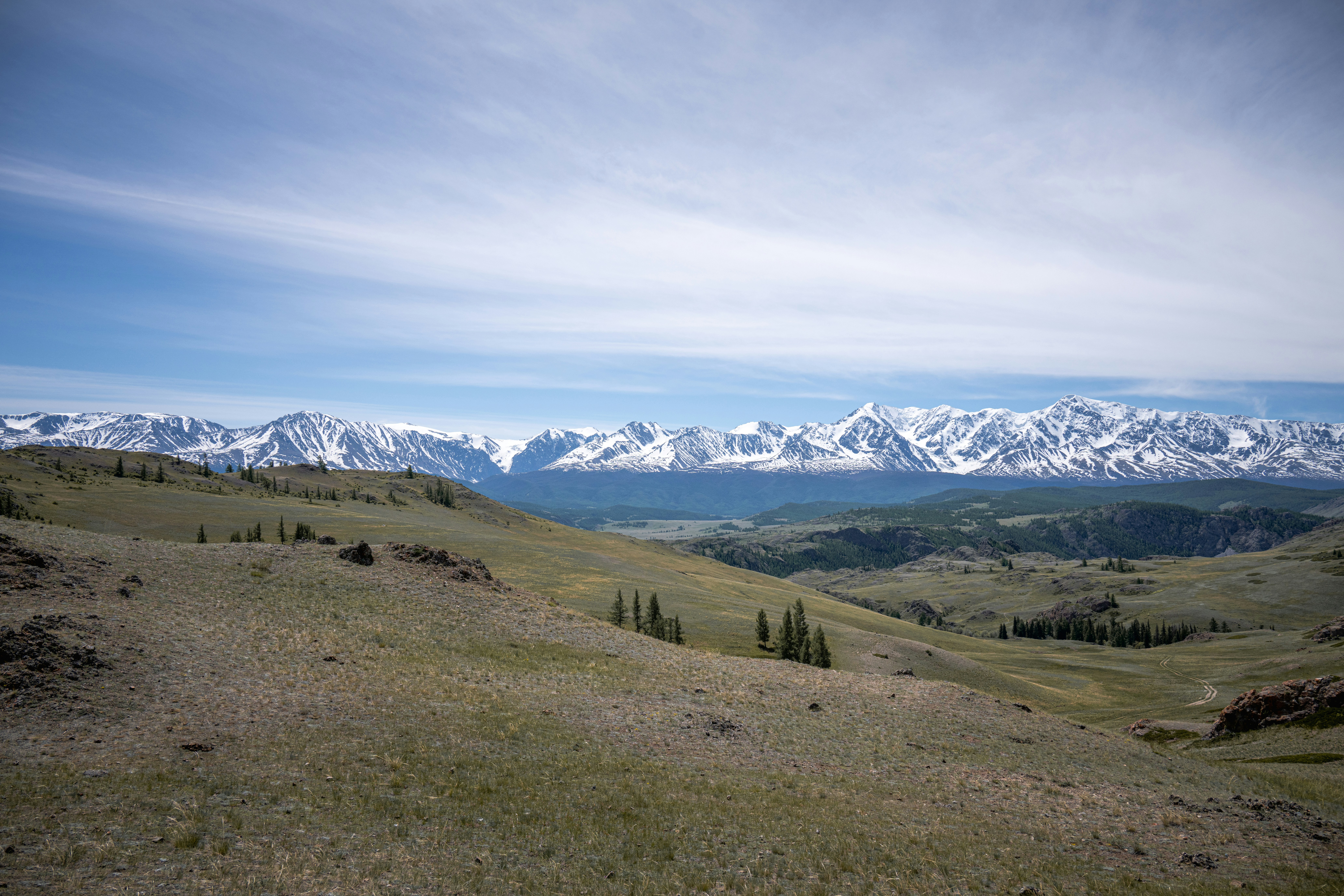a view of the mountains from the top of a hill