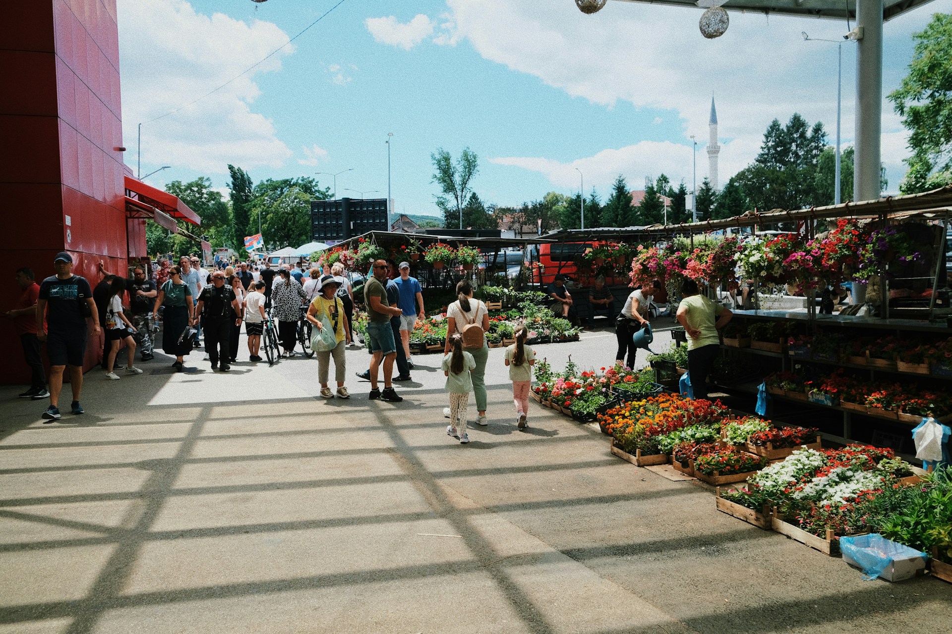 a group of people walking around a market