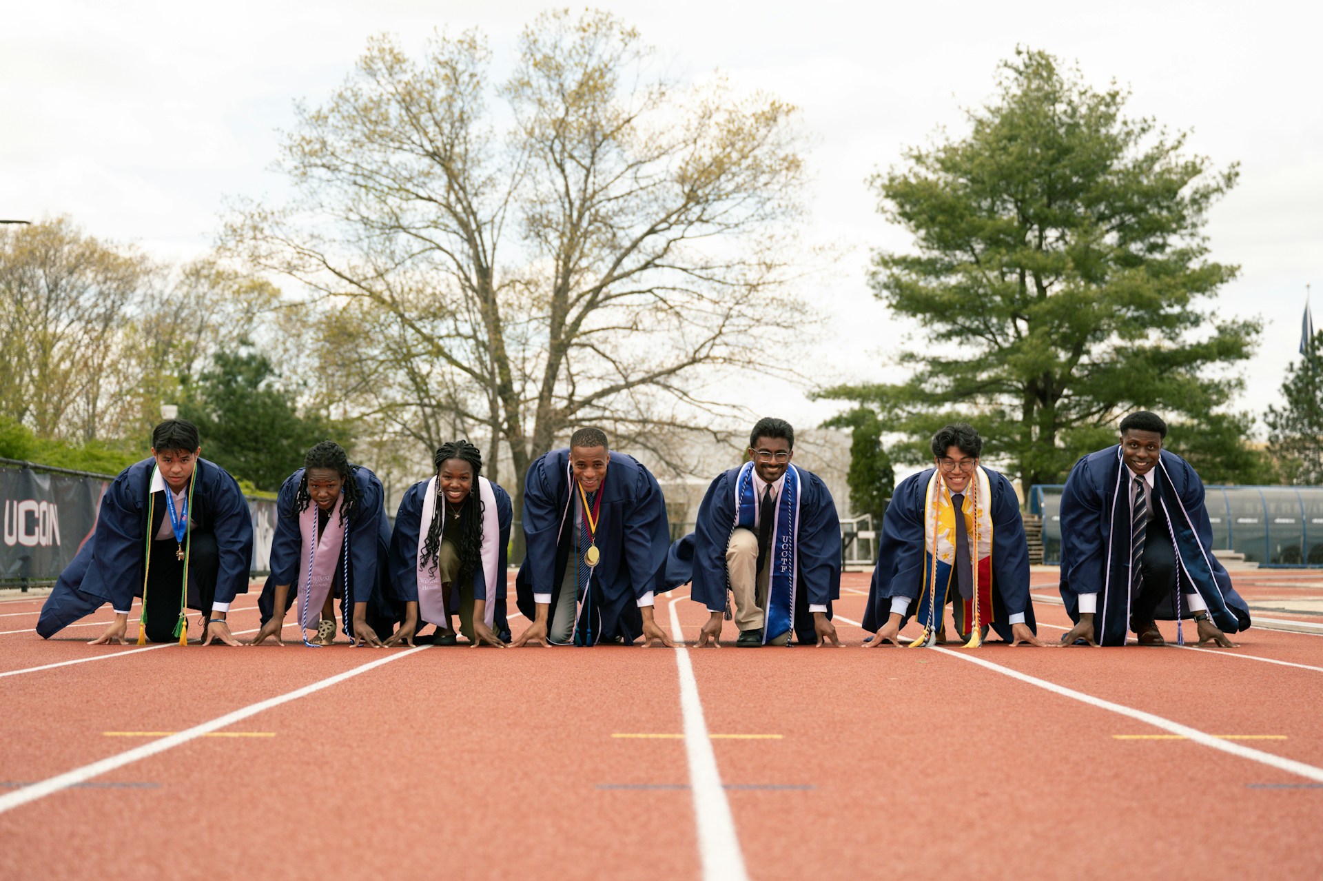 a group of men and women standing on top of a tennis court