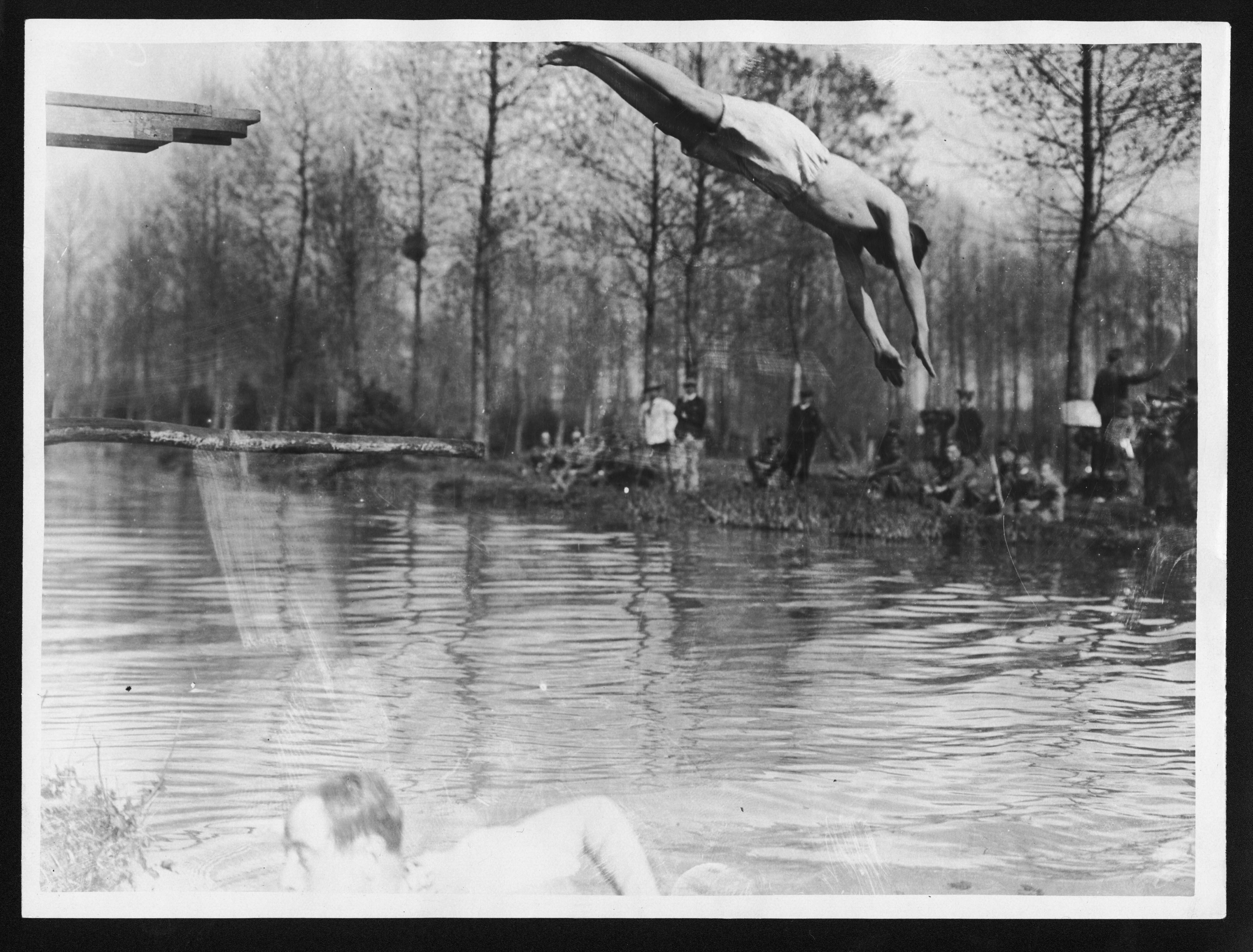 a man diving into a body of water