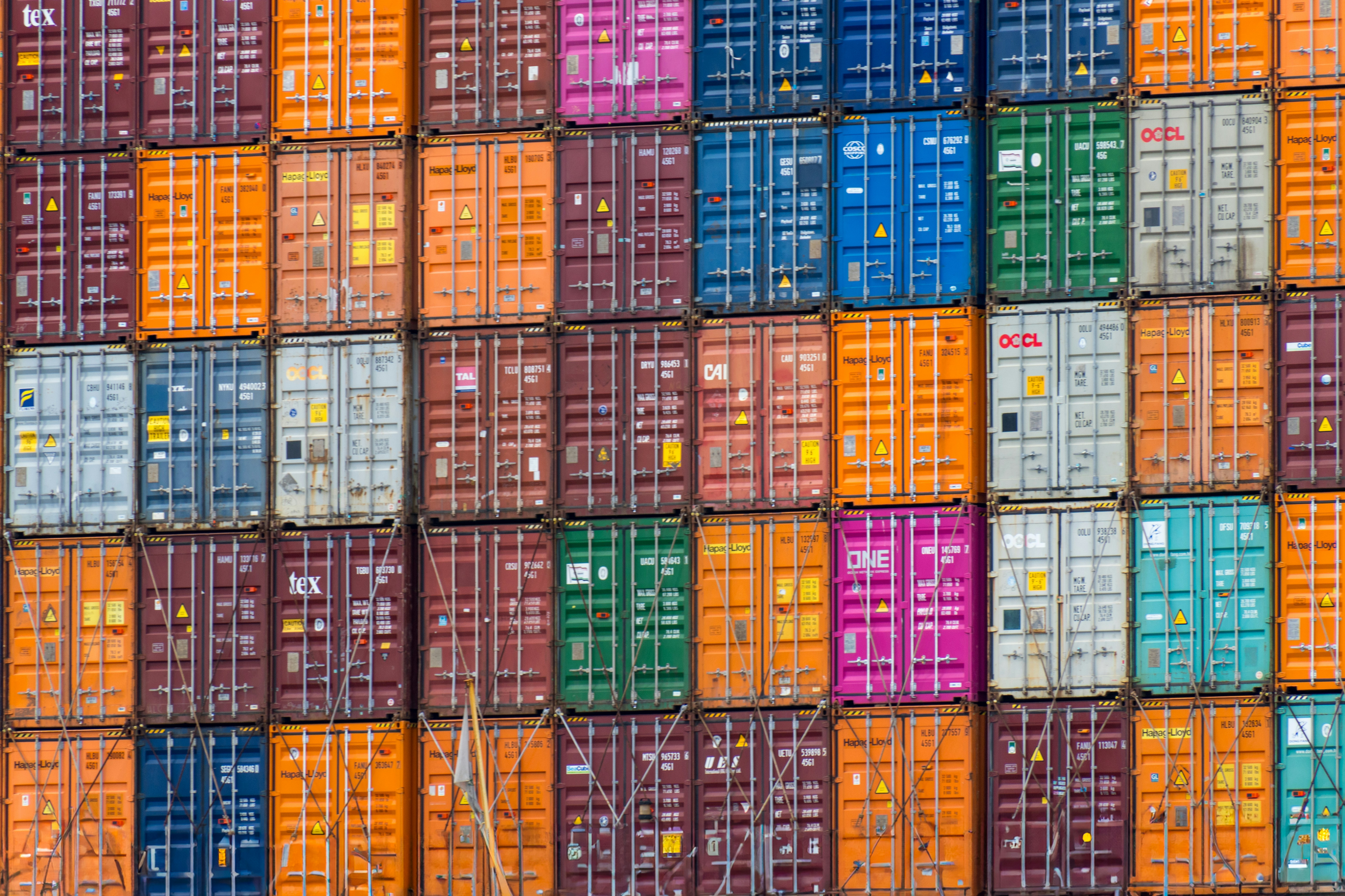 a large stack of multicolored shipping containers