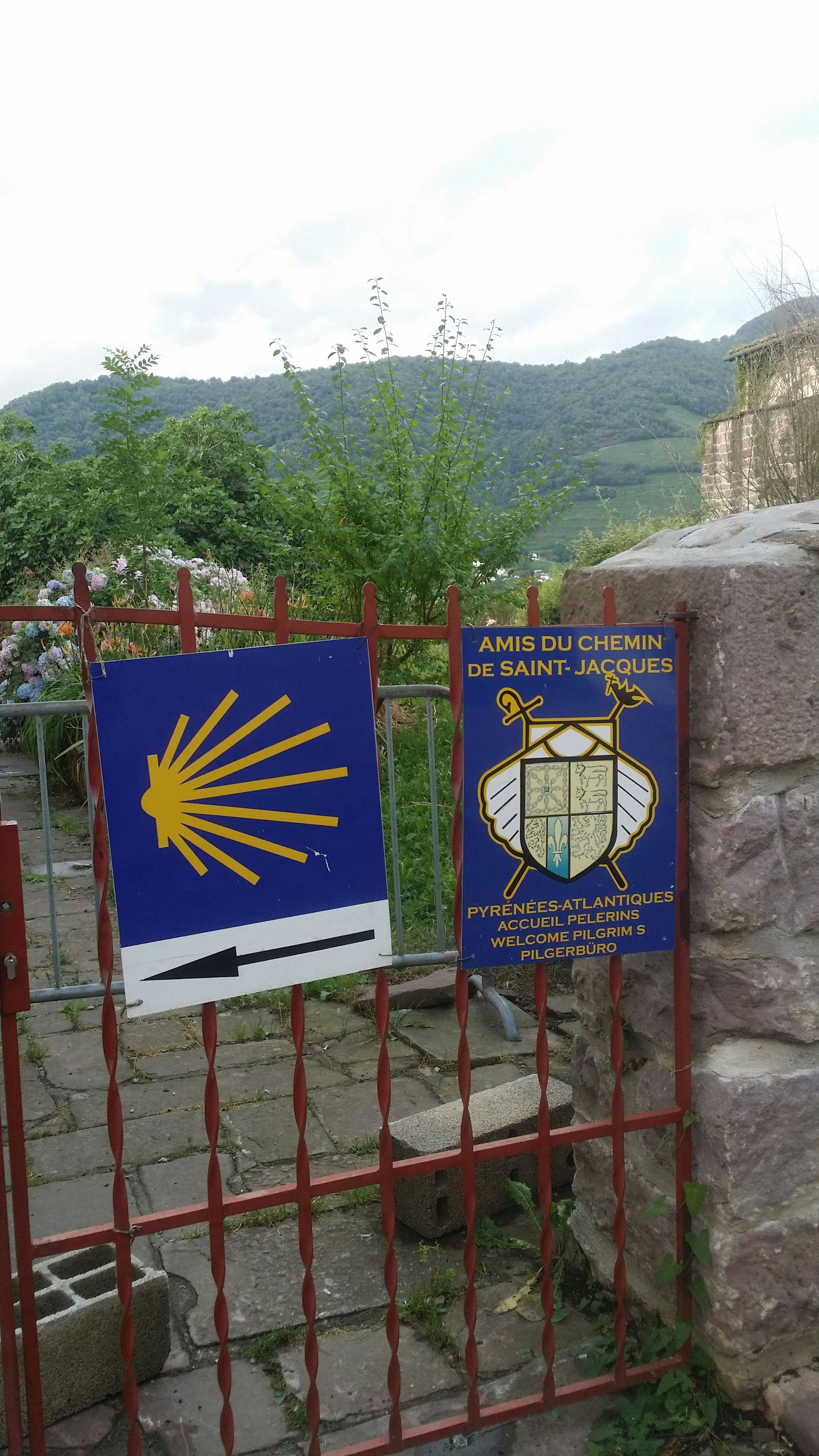a gate with a sign and a flag on it