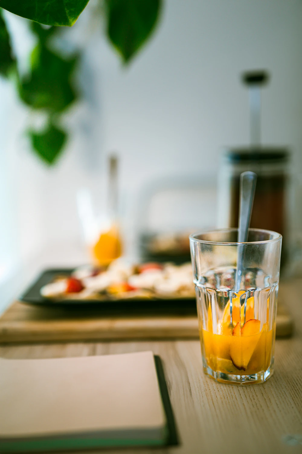 Fresh orange juice served with tea at a restaurant table