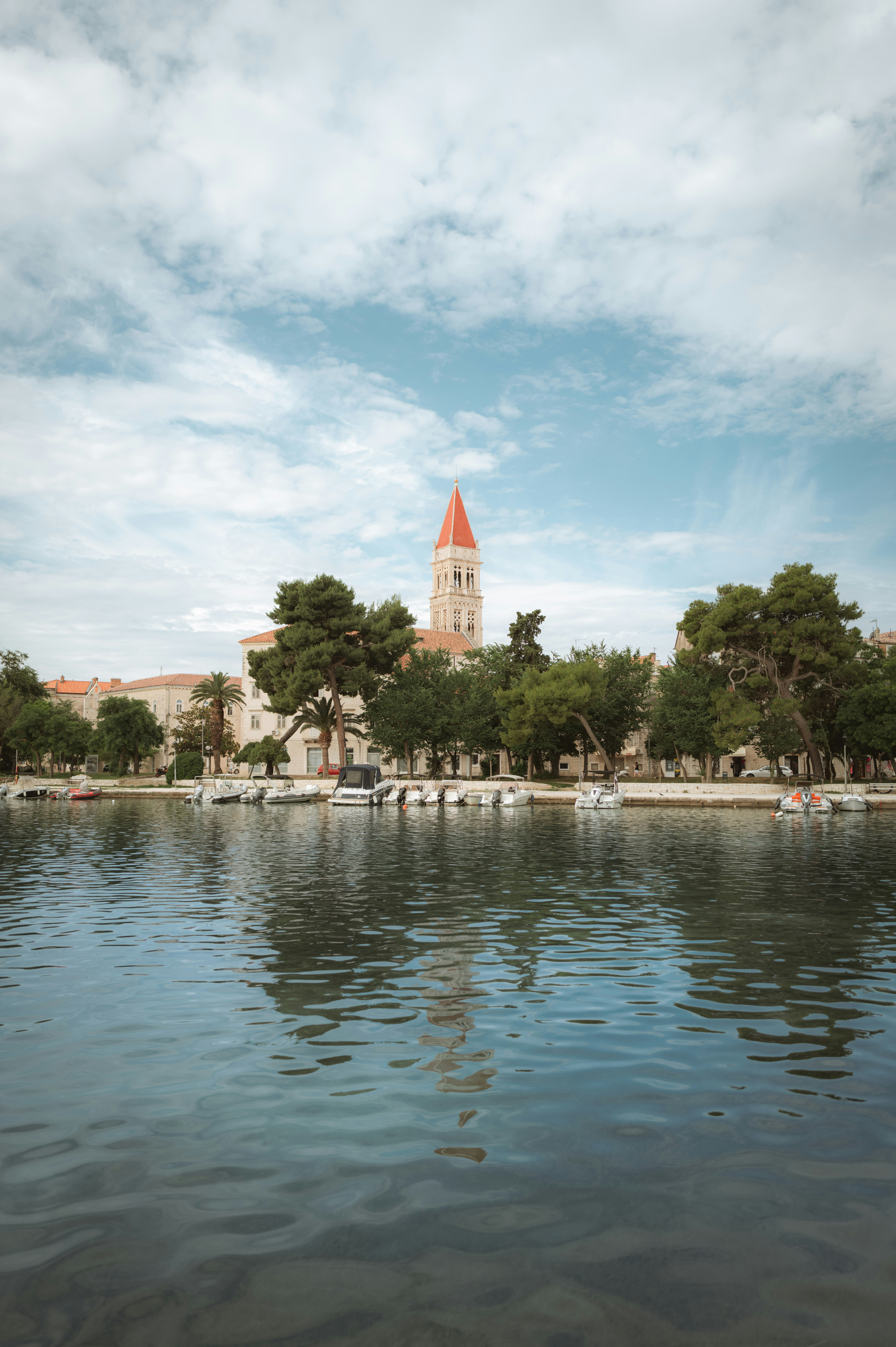 a large body of water with a clock tower in the background
