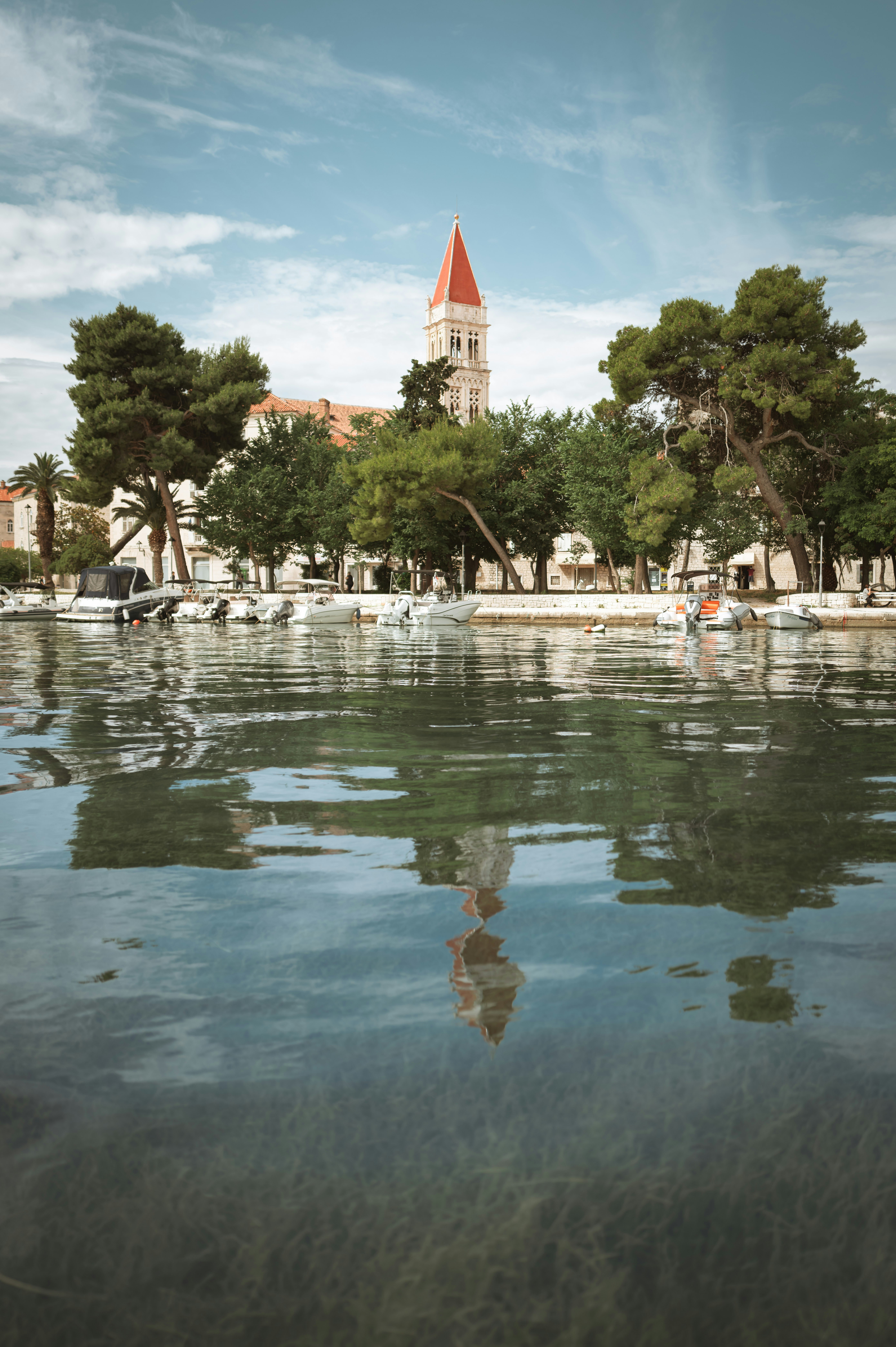 a large body of water with a clock tower in the background