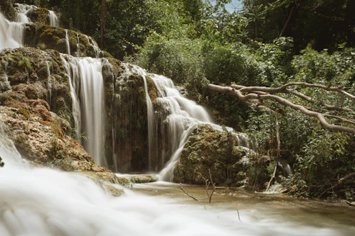 a waterfall with water cascading down it's sides