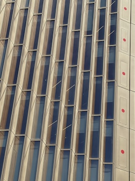 a tall building with lots of windows next to a clock