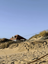 a man riding a surfboard on top of a sandy beach