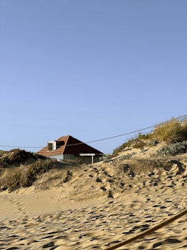 a man riding a surfboard on top of a sandy beach