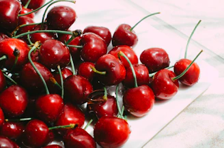 a pile of cherries sitting on top of a table