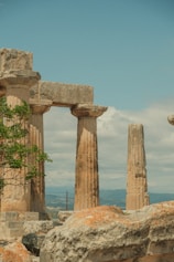 a man riding a horse in front of some ancient ruins