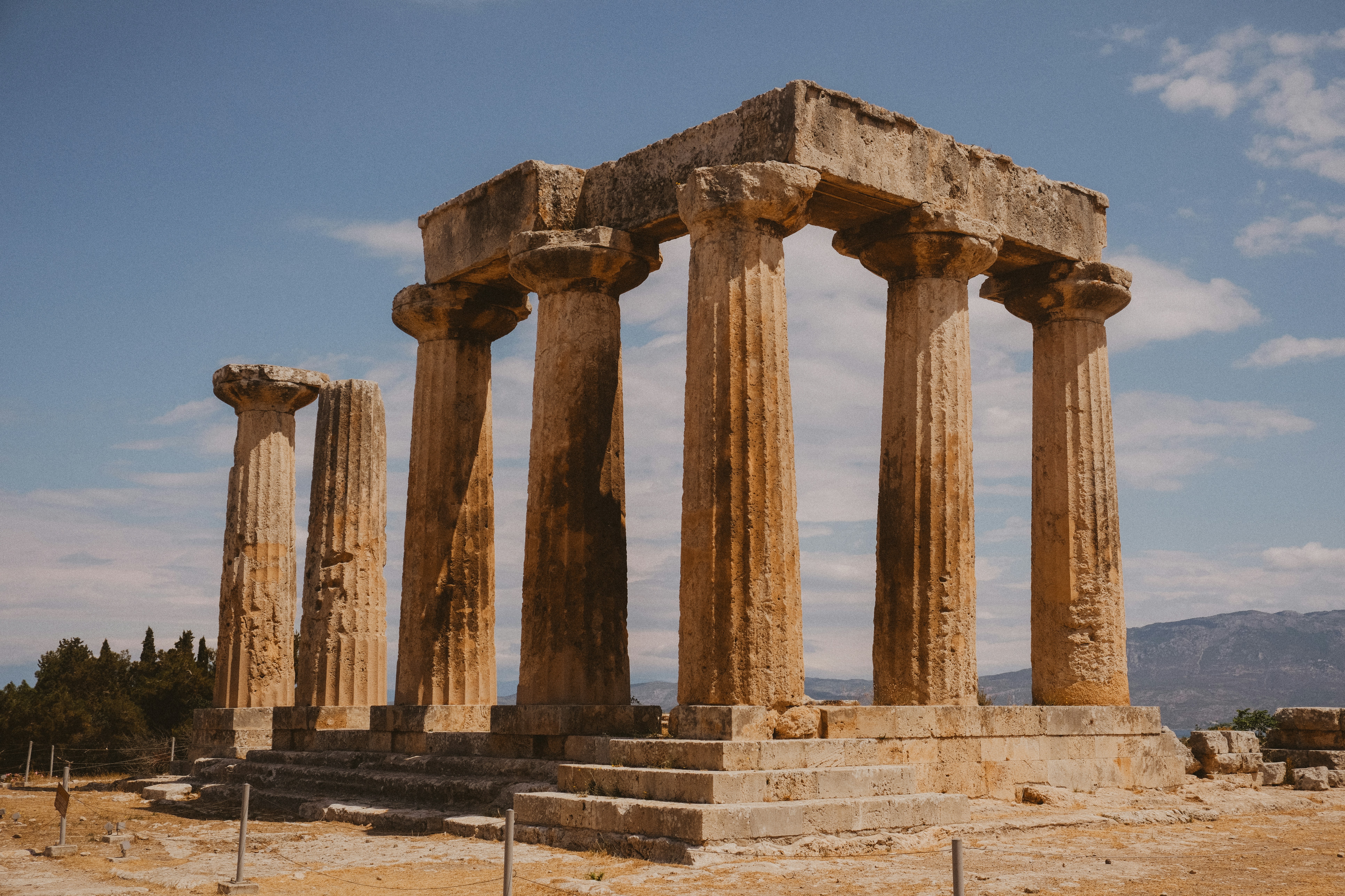 a large stone structure sitting on top of a dirt field, 