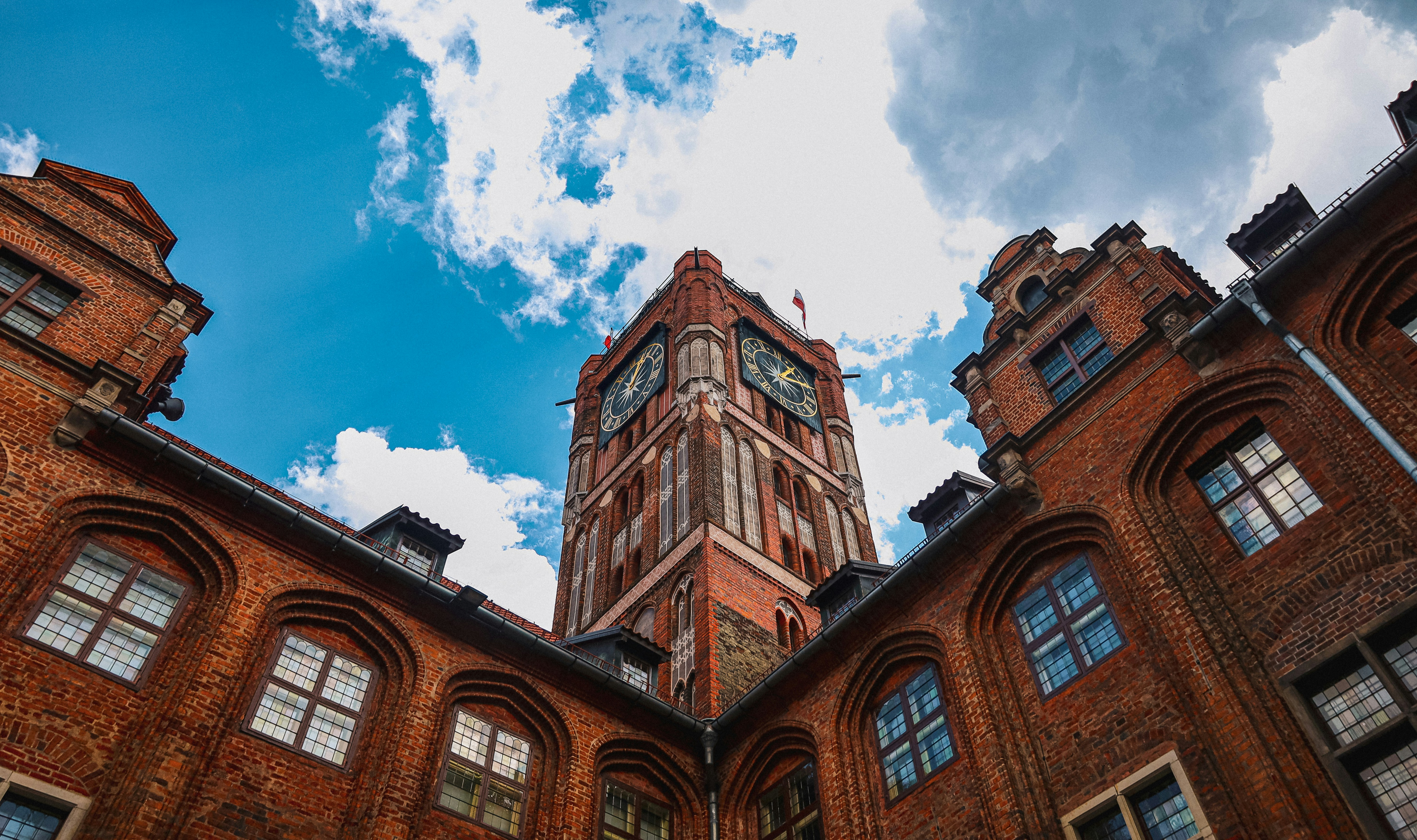 a tall brick clock tower towering over a city