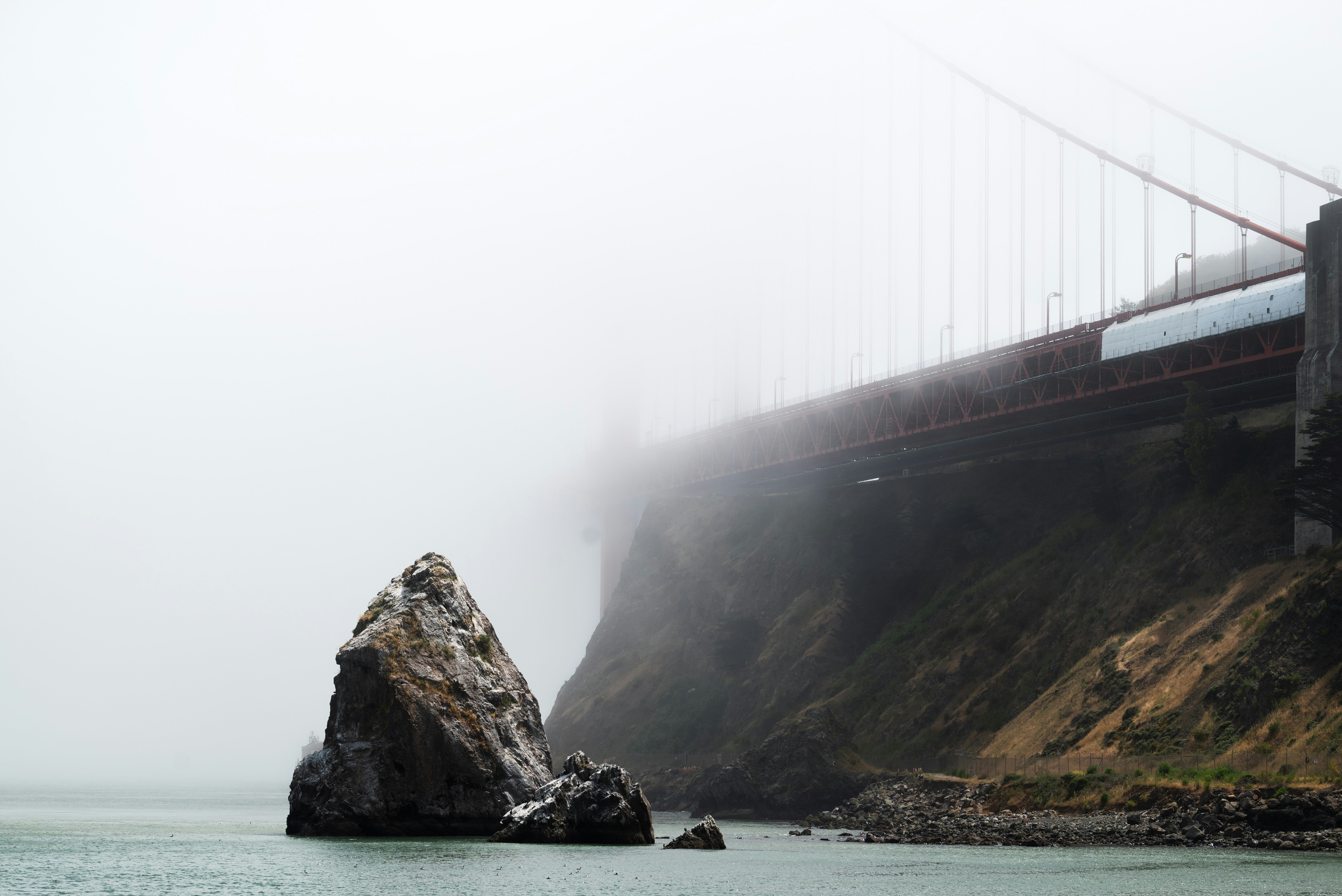 a train traveling over a bridge on a foggy day