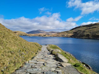 a stone path next to a body of water