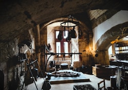 a room filled with lots of clutter next to a window