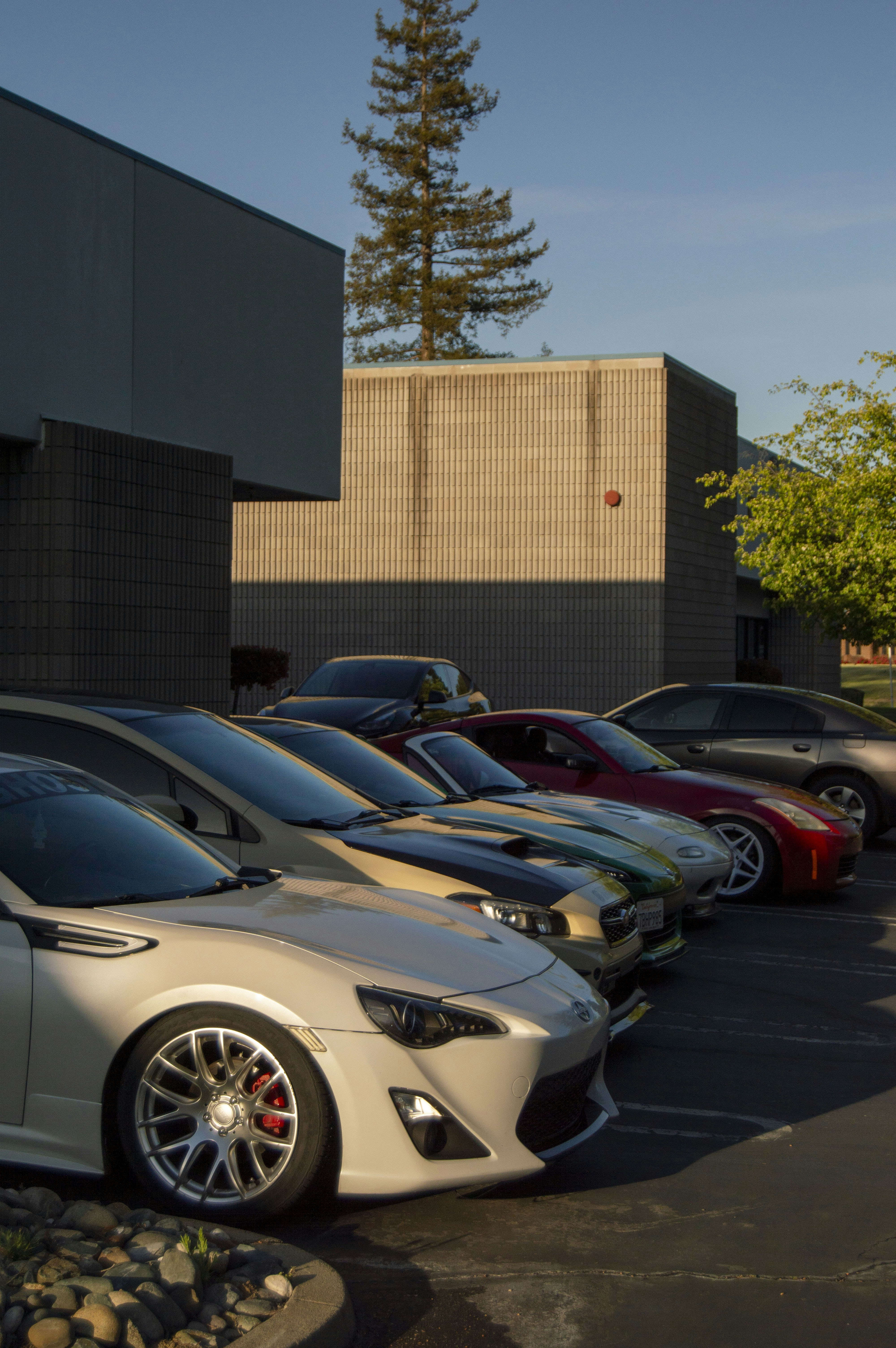 a row of parked cars in a parking lot