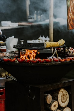 a bbq with a bunch of food cooking on it
