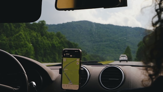 a car dashboard with a cell phone on the dashboard