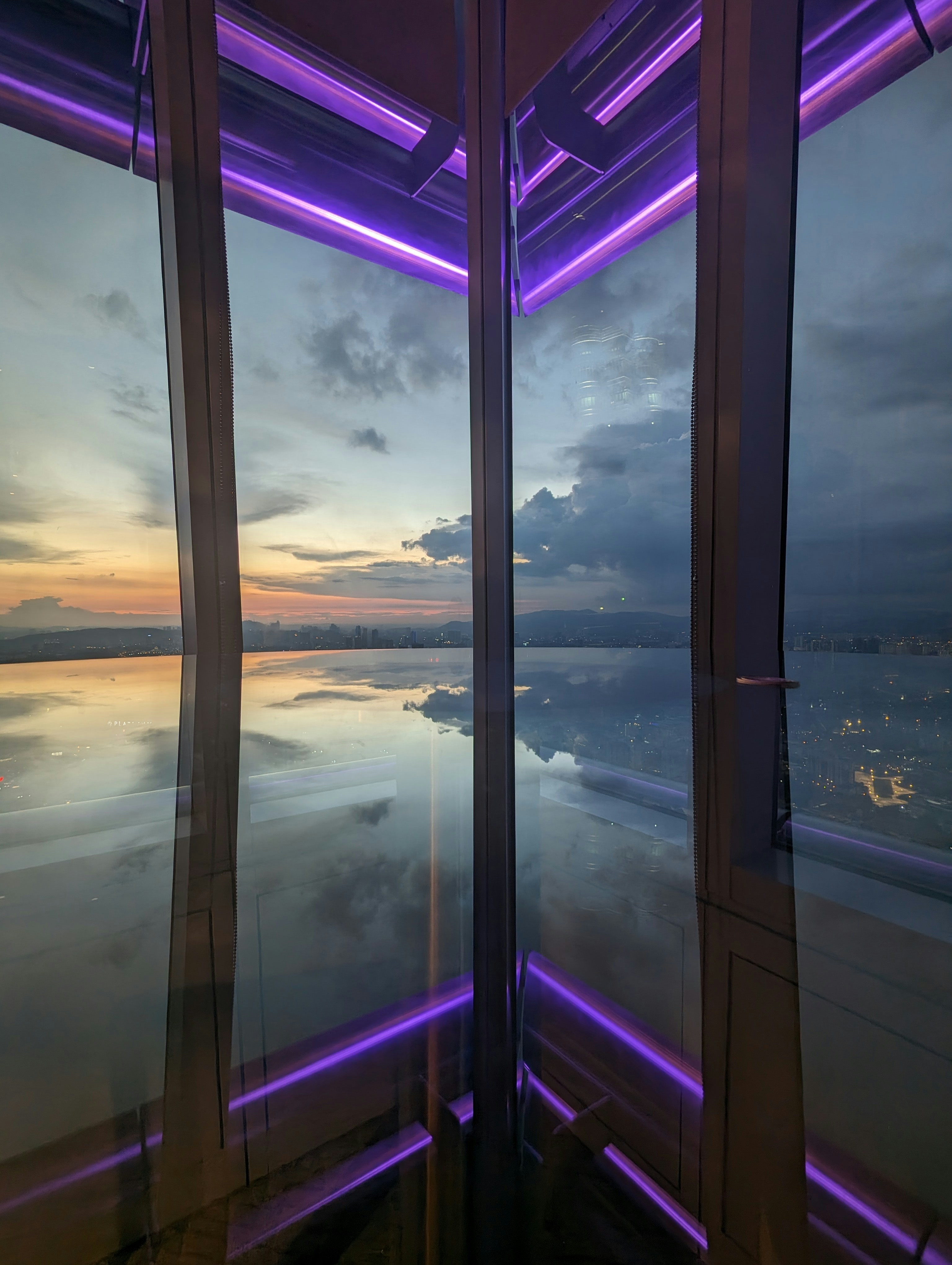 a room with a view of the sky and water