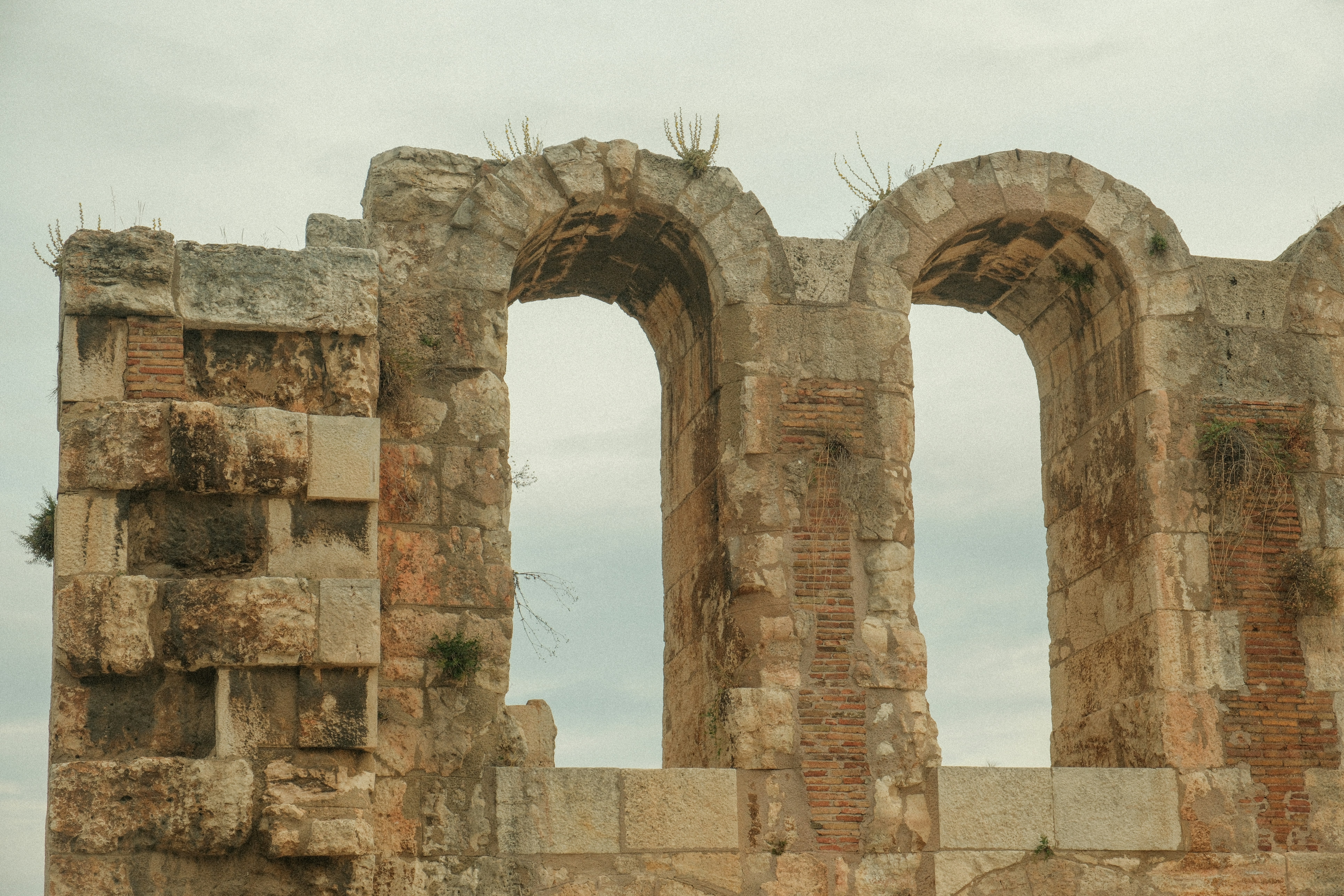 an old stone building with two arched windows, 