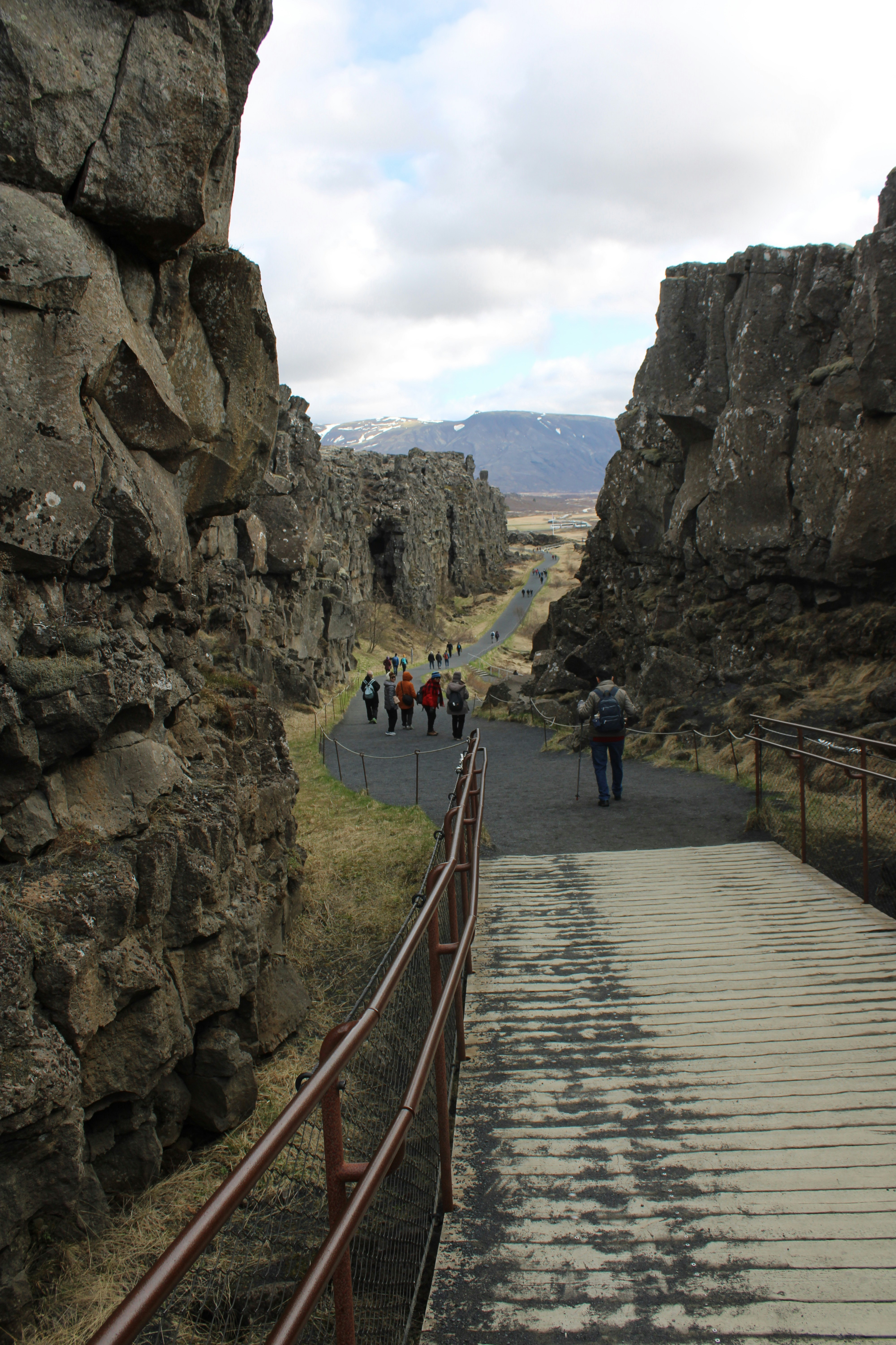 a group of people walking up a rocky path