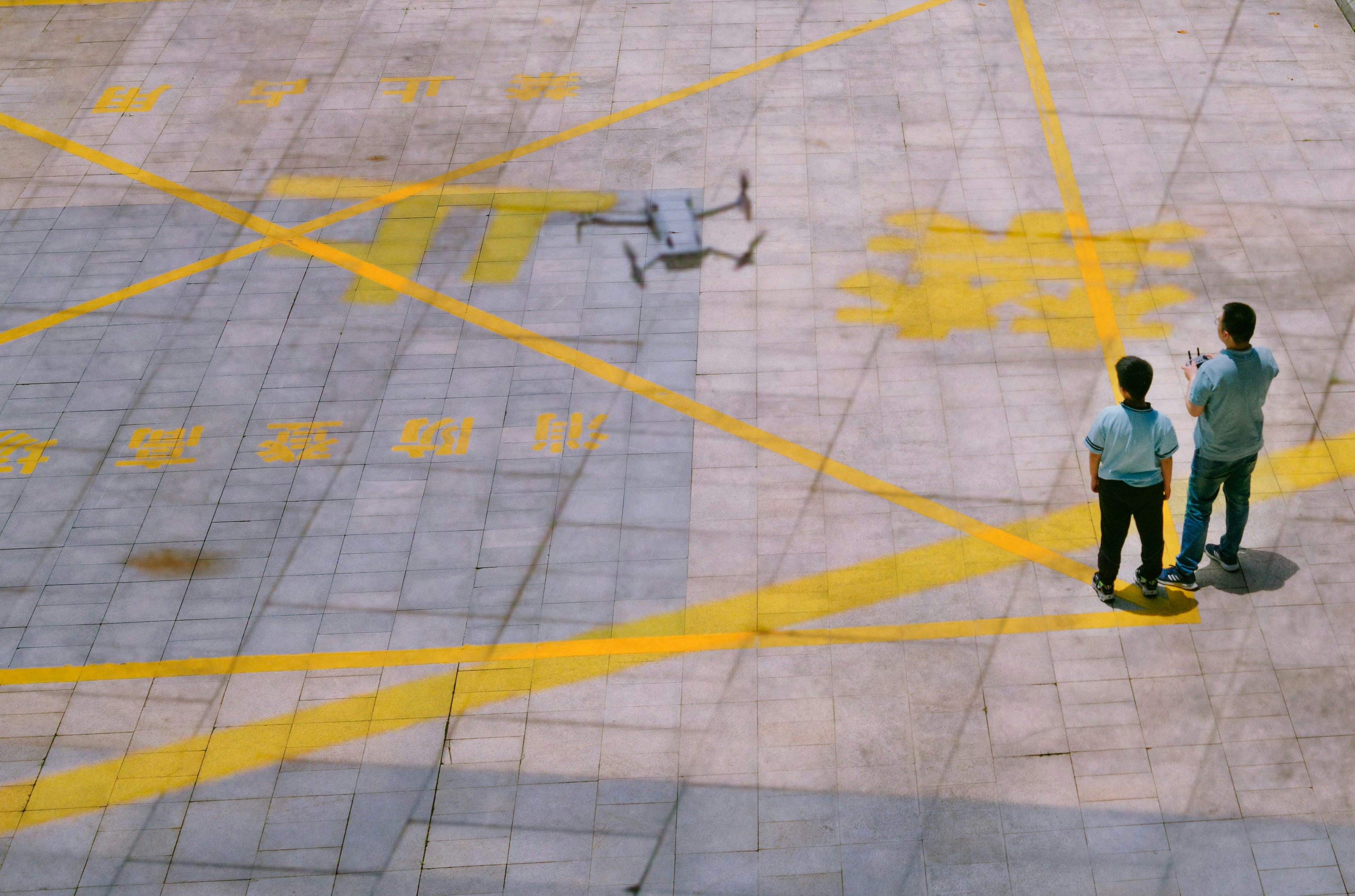 a couple of men standing on top of an airport tarmac
