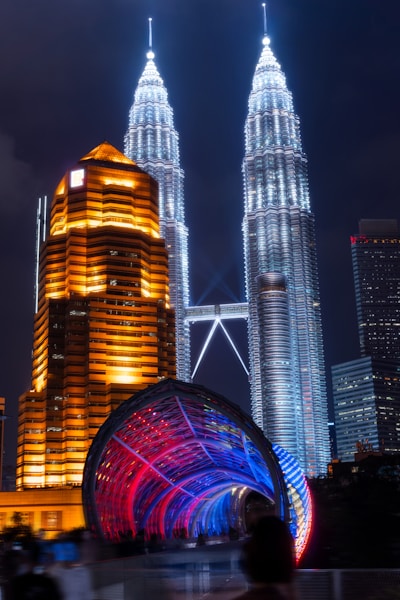 a night scene of a city with tall buildings