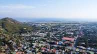an aerial view of a small town with a mountain in the background