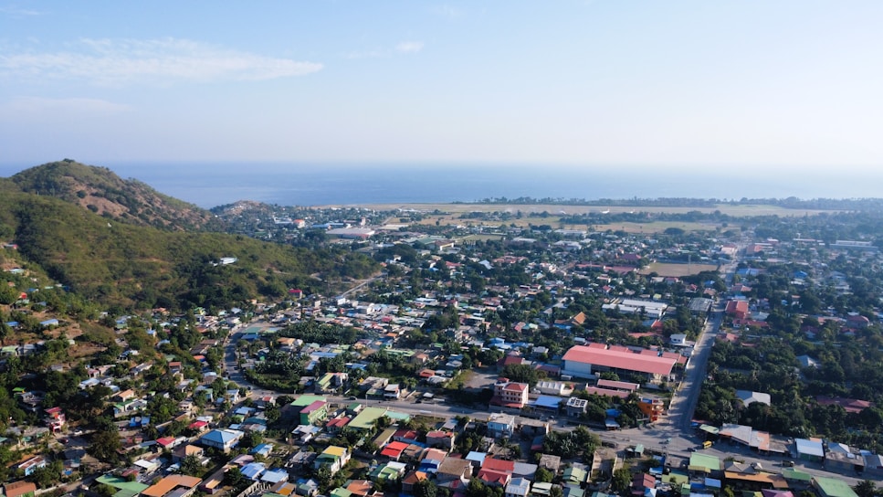 an aerial view of a small town with a mountain in the background