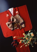 a bouquet of flowers sitting on top of a red cloth