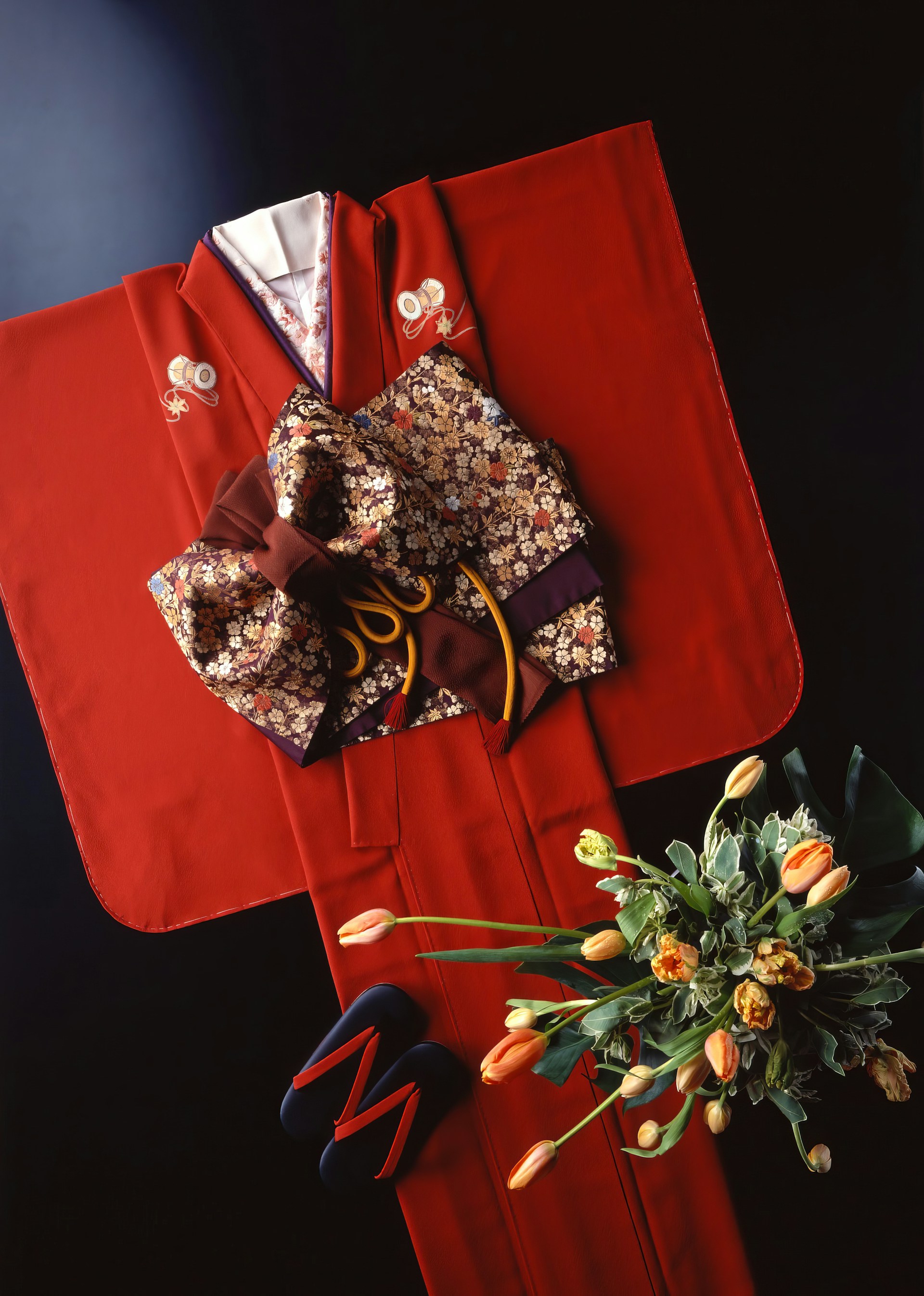 a bouquet of flowers sitting on top of a red cloth