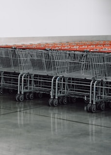 a row of empty shopping carts in a store