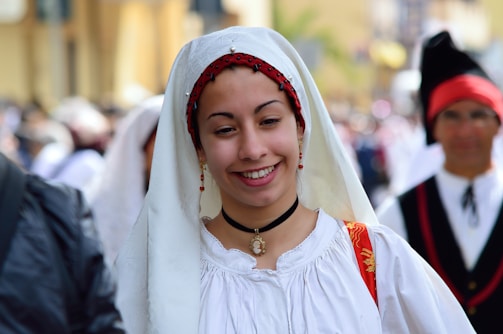a woman wearing a white dress and a red headband
